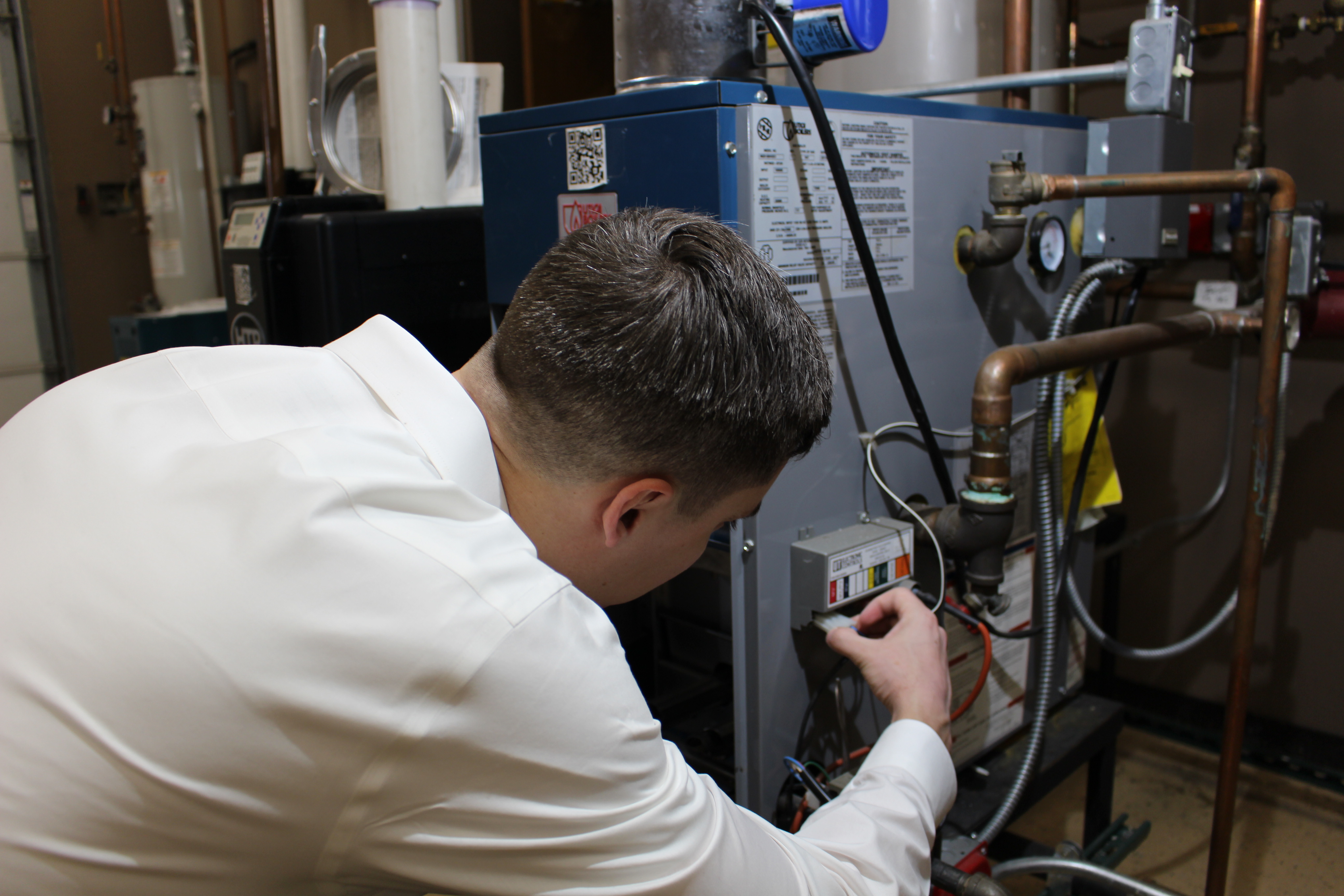 Tech inspecting furnace